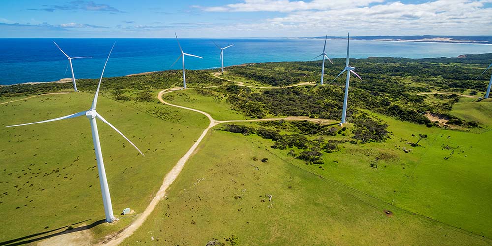 Aerial view of wind farm in rural area on bright sunny day in Australia © Greg Brave - stock.adobe.com