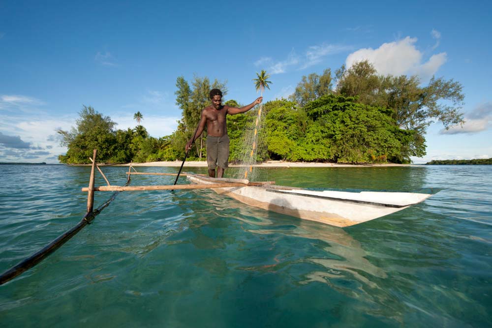 A Papua New Guinea islander paddles his dugout canoe to go fishing © Jürgen Freund / WWF